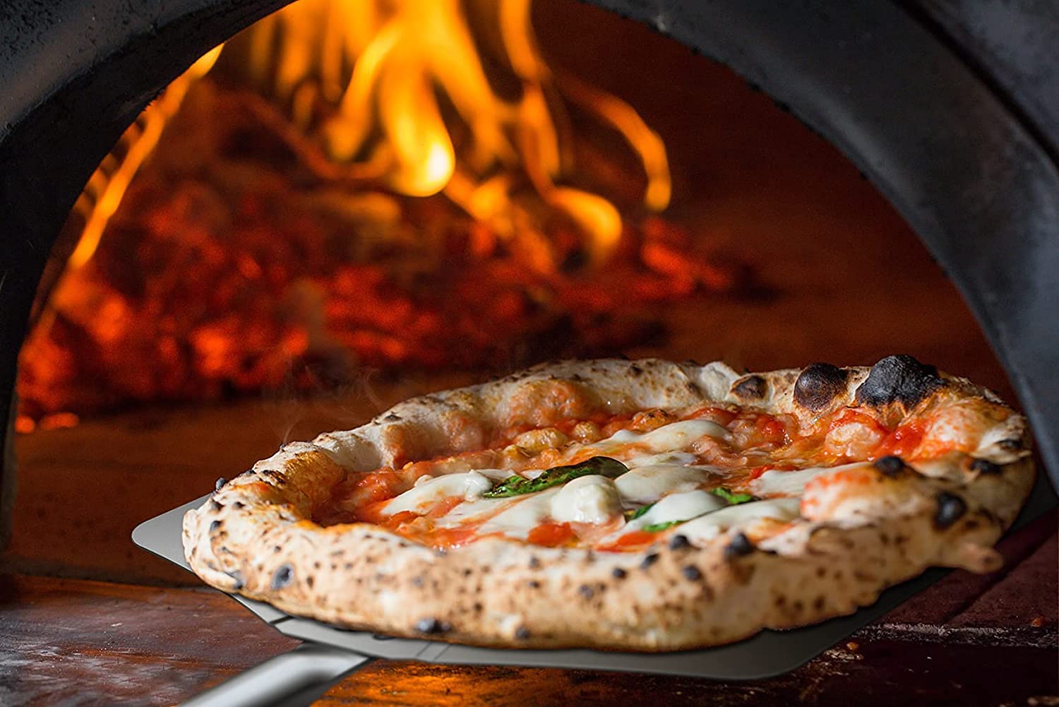 Pizza cooking inside a Pizza Oven Club wood-fired oven