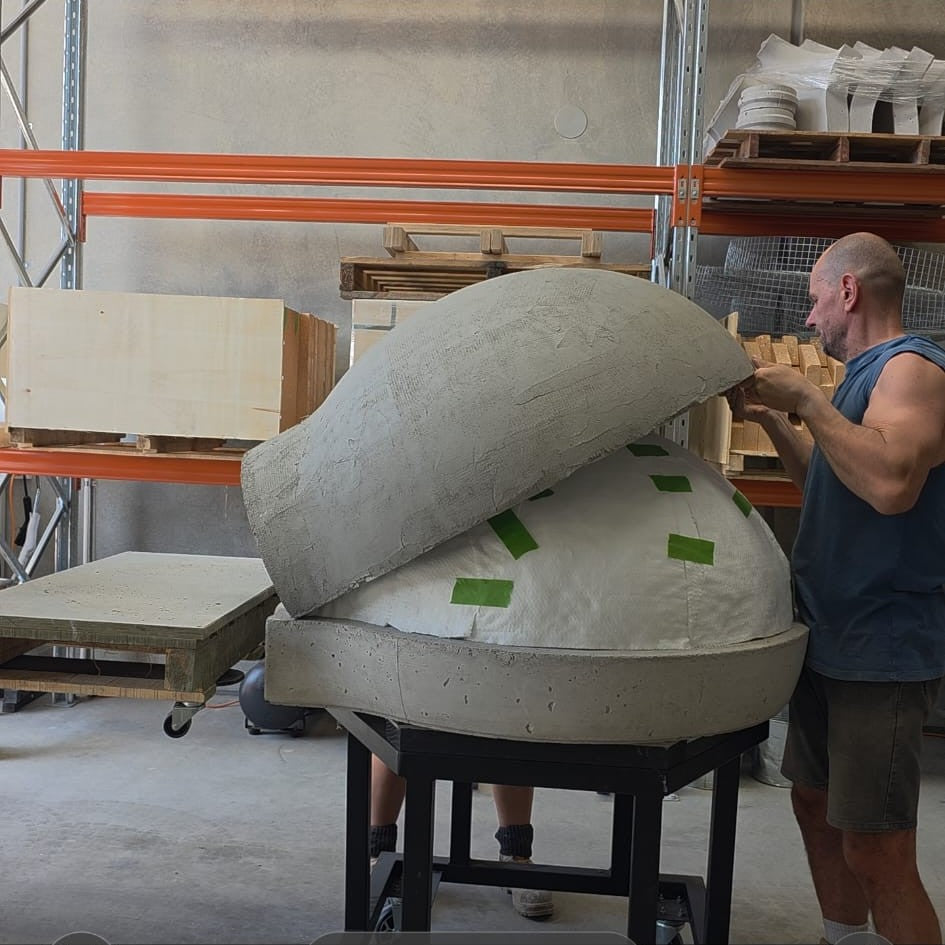 Installing the precast insulating outer shell over the ceramic fibre blanket on a Pizza Oven Club wood-fired oven.