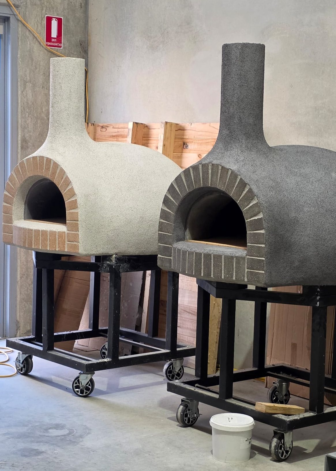 Two ready-made Pizza Oven Club wood-fired pizza ovens in the Landsborough workshop.