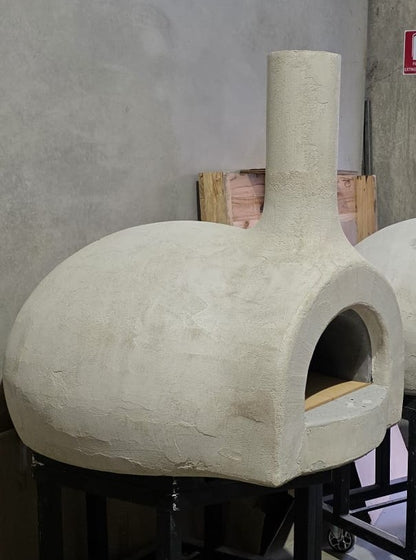 Pre-shaped insulating outer shell fitted over the wood-fired pizza oven before final finishing.